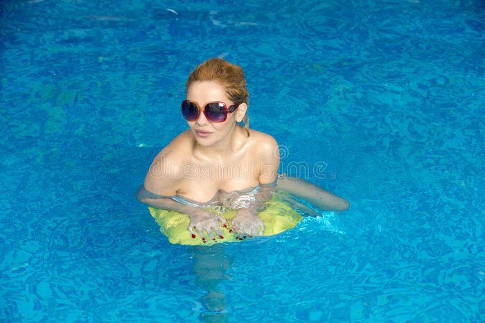 portrait-woman-relaxing-swimming-pool-33380492.jpg