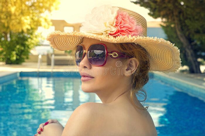 beautiful-woman-sunbathing-pool-33437420.jpg